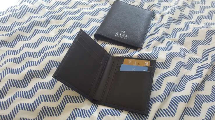 The smaller wallet holds four cards
