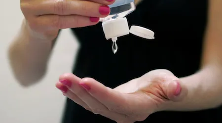 Woman Applying Hand Sanitizer